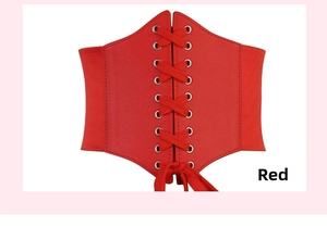 Detail of red corset belt with lace-up leather front and elastic band for women