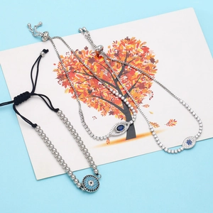 Detailed view of evil eye bracelet set featuring blue zircon pendants and woven cord