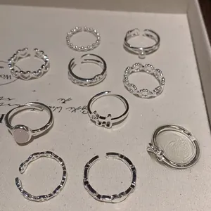 Macro display of S925 sterling silver bow and heart rings with pink gemstone details