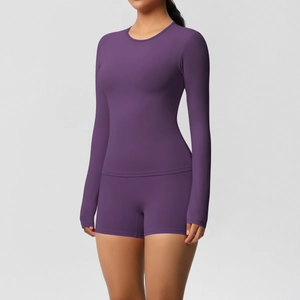 Detailed texture of dark purple seamless long sleeve crop top and matching shorts set