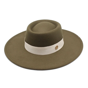 Detail of olive wool fedora hat with cream woven band and golden metallic logo buckle