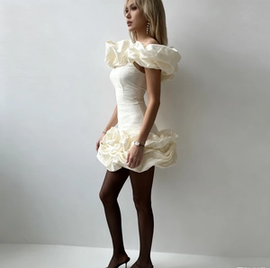 Set top bianco con spalle scoperte e volant e gonna a pieghe per un look minimalista