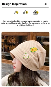 Detail of colorful sunflower and daisy brooches pinned to a knit hat for styling