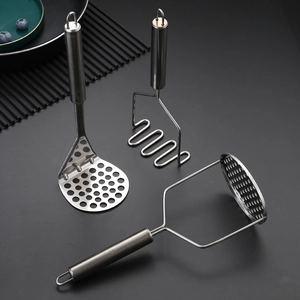Three assorted stainless steel potato mashers with different heads on a dark countertop