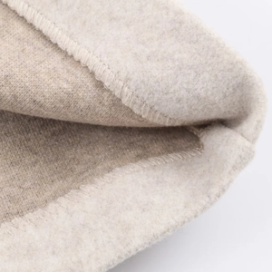 Macro detail of the warm fleece lining and fine stitching on a short wool coat