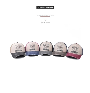 Detail view of five colors of vintage washed cotton baseball caps with skull embroidery