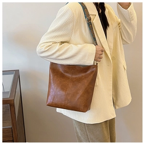 Brown faux leather bucket bag with retro ethnic pattern strap for daily casual wear