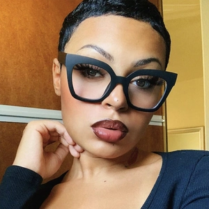 Close-up of black cat-eye glasses on a female model showing the matte texture and large frame