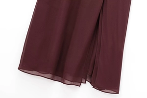 Detailed view of burgundy chiffon dress hem featuring multi-layered sheer fabric