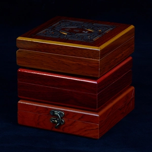Three stacked vintage wood jewelry gift boxes with hollow carvings and metal clasps