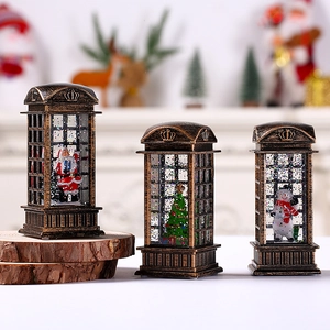 Close-up of bronze Christmas phone booth lanterns with Santa and snowman scenes inside