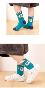 Detail of blue cotton socks for kids with cartoon elephant pattern and striped cuffs