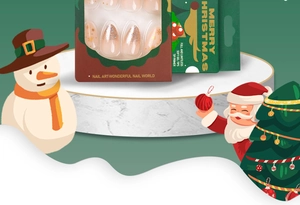 Close-up of Christmas press-on nails with snowflakes and gold glitter on marble stand