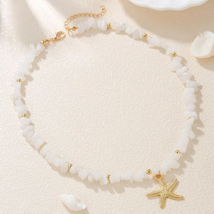 Detail of adjustable seashell anklet with white crushed stones and golden starfish charm