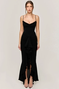 Detailed view of black slim-fit evening dress with tiered ruffles and asymmetric hemline