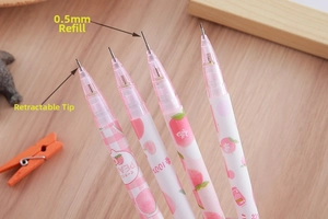 Detail of 0.5mm peach themed mechanical pencils with retractable tips on wooden desk