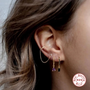 Detailed side view of 925 sterling silver gold earrings with purple and black gemstones