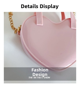 Close-up of pink heart-shaped bag with gold chain and detailed stitching accents