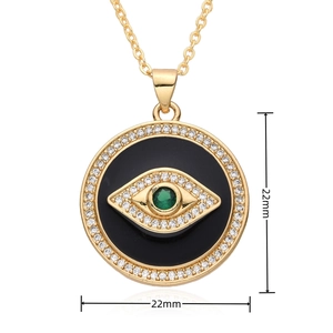 Macro shot of 22mm evil eye pendant with green gemstone and white zircons on black enamel