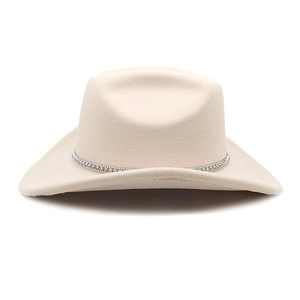 Detail view of beige wool felt cowboy hat with silver rhinestone band and curved brim