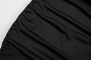 Macro shot of black ruched fabric texture and fine horizontal ribs on a bodycon dress