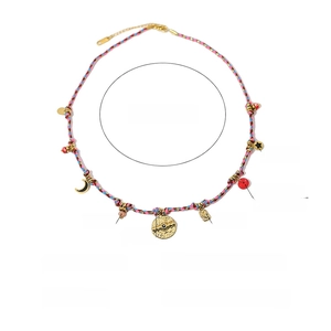 Detail of woven chain necklace with 1.5cm 18K gold plated charms and red turquoise