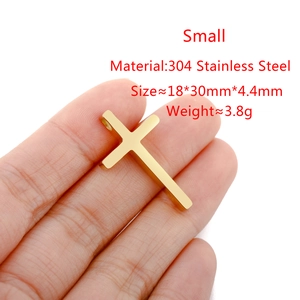 Detailed view of a small golden stainless steel cross pendant showing size measurements