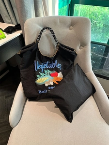 Detail of black nylon tote with vegetable embroidery and durable rope handle