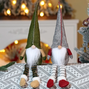 Detail of Christmas gnome plush dolls with striped long legs and pointed felt hats