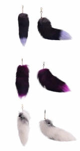 Three variants of oversized faux fox fur tail keychains with gold metal clips in detail