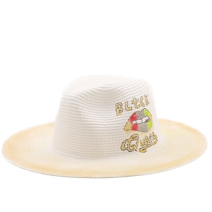Detail of white straw hat with colorful lip embroidery and BLACK Queen lettering