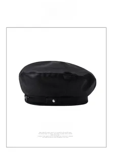 Close-up of black PU leather beret featuring a silver metal chain and round rivets