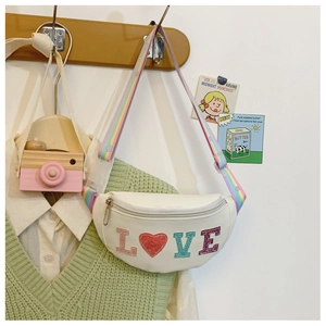 Detailed view of white kids crossbody bag with colorful LOVE letters on a wooden hanger