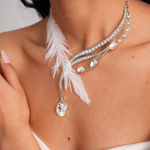 Detail showing elegant silver feather necklace with sparkling rhinestones and oval pendant