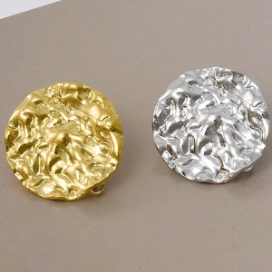 Detail of 304 stainless steel earrings with gold and silver hammered lava texture finish