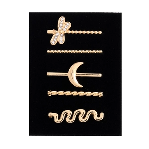 Detail of five-piece gold dragonfly and moon hair pin set with sparkling rhinestones
