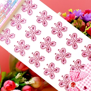 Close-up of pink butterfly acrylic crystal gemstone stickers on a white backing sheet