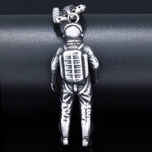 Macro view of the astronaut pendant showing detailed textures and a vintage silver finish