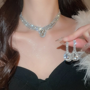 Sparkling silver waterdrop necklace and earrings set with crystal rhinestones on a model