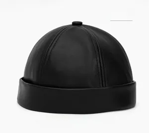 Detailed view of black PU leather docker hat showing premium grain texture and stitching