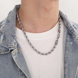 Detail of a silver twisted rope chain necklace worn by a model for a classic look