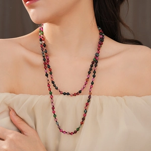 Detail view of Bohemian colorful agate beaded long necklace layered on a fashion model