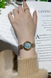 Elegant woman's wrist watch with blue mother-of-pearl dial and two-tone steel bracelet