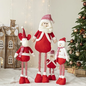 Christmas snowman and Santa plush dolls with telescopic legs in a warm home decor setting