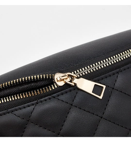 Close-up of black quilted faux leather waist bag with premium gold zipper detail