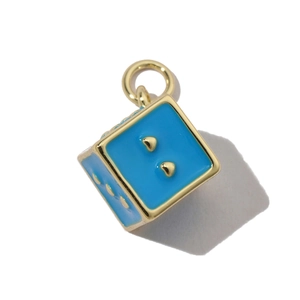 Macro detail of sky blue enamel heart dice pendant with gold-plated metal edges and ring