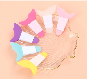 Detailed view of 5 silicone eyelash shields in various colors on a shell shaped tray