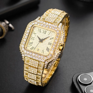 Macro shot of iced-out gold square watch bezel with Roman numerals and crystals