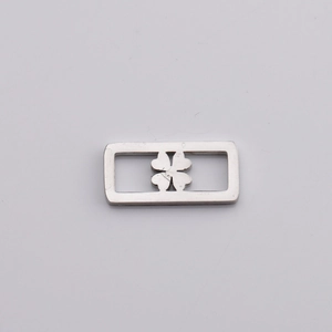 Macro shot of silver stainless steel rectangular pendant with clover cutout detail