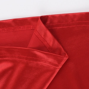 Close-up of vibrant red knit dress showing high-quality double-needle stitching detail